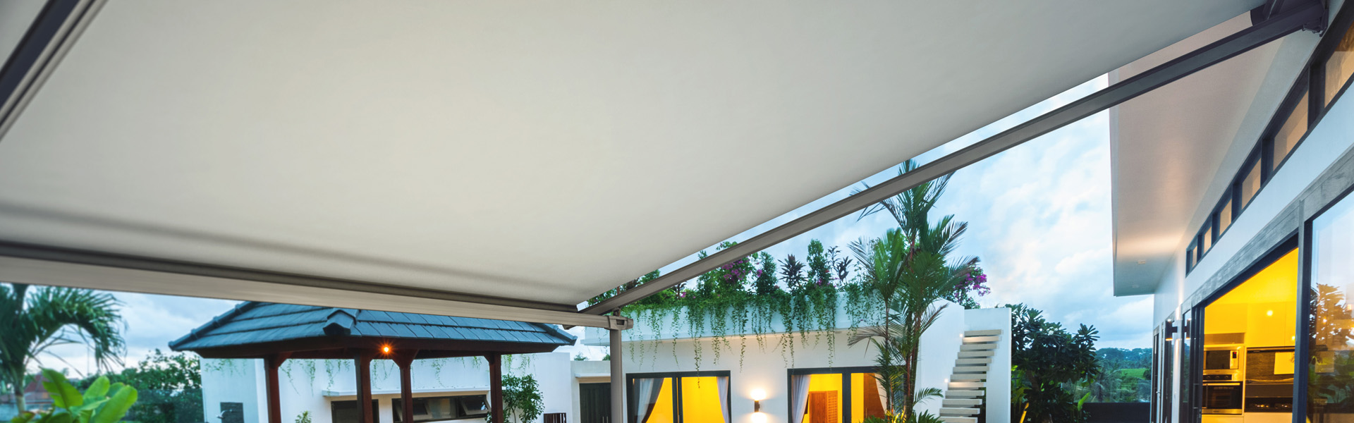 Exterior view of a modern tropical villa with swimming pool and gazebo